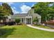 Beautiful brick home with lush green lawn, complemented by a decorative black picket fence at 129 2Nd Se Ave, Atlanta, GA 30317