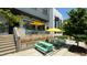 Modern restaurant exterior with outdoor seating, umbrellas, and vibrant landscaping at 129 2Nd Se Ave, Atlanta, GA 30317
