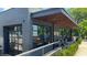 An outside view of a stylish restaurant building with a patio and garage-style windows at 129 2Nd Se Ave, Atlanta, GA 30317