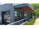 Modern building exterior with gray brick, large windows, and an inviting outdoor dining area at 129 2Nd Se Ave, Atlanta, GA 30317