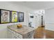 View of granite kitchen island with attached eating bar, looking toward hallway and doorways at 129 2Nd Se Ave, Atlanta, GA 30317