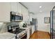 Modern kitchen with stainless appliances, gas range, and granite countertops at 129 2Nd Se Ave, Atlanta, GA 30317
