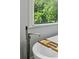 Close-up of freestanding faucet and bamboo caddy on tub with a view to the outdoors at 129 2Nd Se Ave, Atlanta, GA 30317