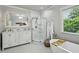 Bathroom featuring double sink vanity, glass shower, and soaking tub under a window at 129 2Nd Se Ave, Atlanta, GA 30317