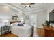 Comfortable main bedroom with ceiling fan, tray ceiling, ensuite bathroom, and wood floors at 129 2Nd Se Ave, Atlanta, GA 30317