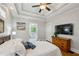 Comfortable main bedroom with wood floors, fan, and ensuite bathroom featuring a soaking tub at 129 2Nd Se Ave, Atlanta, GA 30317