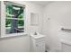 Bathroom featuring a window, white sink, and a mirror at 4202 Maplewood Dr, Decatur, GA 30035