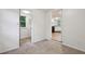 View of a bedroom with neutral carpet and wall paint colors featuring doorways to the bathroom and kitchen at 4202 Maplewood Dr, Decatur, GA 30035
