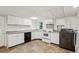 Kitchen with white cabinetry, dark appliances, and tan flooring at 4202 Maplewood Dr, Decatur, GA 30035