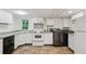 Kitchen featuring white cabinetry, tile floor, and modern appliances at 4202 Maplewood Dr, Decatur, GA 30035