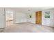 Bright living room with plush carpeting and access to the kitchen at 4202 Maplewood Dr, Decatur, GA 30035