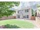 Large, well-maintained backyard with a lush lawn, wood fence, and the home's exterior at 5730 Weddington Dr, Cumming, GA 30040