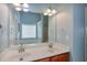 Bathroom vanity with double sinks, a large mirror, and granite countertops at 5730 Weddington Dr, Cumming, GA 30040