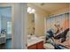 A charming full bathroom with a whimsical shower curtain and light-colored walls at 5730 Weddington Dr, Cumming, GA 30040