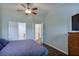 This bedroom has hardwood floors, a ceiling fan, stylish wall color, and an ensuite bathroom at 5730 Weddington Dr, Cumming, GA 30040