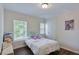 Bedroom with hardwood floors, natural light, and a stylish, comfortable design at 5730 Weddington Dr, Cumming, GA 30040