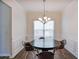 This dining room features hardwood floors, wainscotting, and a modern chandelier at 5730 Weddington Dr, Cumming, GA 30040