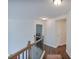 Upstairs hallway featuring hardwood floors and wood and iron railings at 5730 Weddington Dr, Cumming, GA 30040