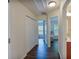 Hallway featuring hardwood floors and white doors at 5730 Weddington Dr, Cumming, GA 30040