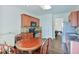 Eat-in kitchen featuring cherry cabinets, hardwood floors, and stainless steel appliances at 5730 Weddington Dr, Cumming, GA 30040