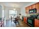 Eat-in kitchen featuring cherry cabinets, hardwood floors, and stainless steel appliances at 5730 Weddington Dr, Cumming, GA 30040
