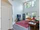Spacious living room with tall ceilings, large windows, fireplace, and hardwood floors at 5730 Weddington Dr, Cumming, GA 30040