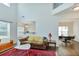 Spacious living room with tall ceilings, large windows, hardwood floors, dining room, and open layout at 5730 Weddington Dr, Cumming, GA 30040