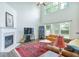 Spacious living room with tall ceilings, large windows, fireplace, and hardwood floors at 5730 Weddington Dr, Cumming, GA 30040