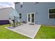 Backyard with patio and furniture, exterior door and a grassy lawn area at 7730 Demeter Dr, Fairburn, GA 30213