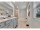 Bright bathroom featuring a granite countertop, tiled floors, and natural light at 7730 Demeter Dr, Fairburn, GA 30213