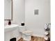 Cozy half bathroom with modern fixtures, wood floors, and stylish decor at 7730 Demeter Dr, Fairburn, GA 30213