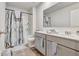 Bathroom featuring a double sink vanity and shower-tub combo at 7730 Demeter Dr, Fairburn, GA 30213