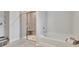 Tiled bathroom shows stand-up shower and tub with towels at 7730 Demeter Dr, Fairburn, GA 30213