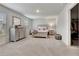 Spacious primary bedroom boasts neutral gray furniture, plush carpeting, and lots of natural light at 7730 Demeter Dr, Fairburn, GA 30213