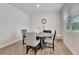 Bright dining area with wood floors, a round table, and natural light from the window at 7730 Demeter Dr, Fairburn, GA 30213