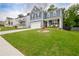 Beautiful home with a lush green lawn, complemented by mature trees in a desirable neighborhood at 7730 Demeter Dr, Fairburn, GA 30213