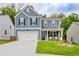 Charming two-story home featuring a well-manicured lawn, attached garage, and inviting front porch at 7730 Demeter Dr, Fairburn, GA 30213