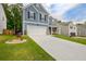 Attractive blue home featuring a two-car garage and landscaped front yard, in a pleasant residential area at 7730 Demeter Dr, Fairburn, GA 30213