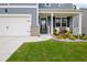 Inviting front porch featuring a seating area and well-manicured landscaping, enhancing curb appeal at 7730 Demeter Dr, Fairburn, GA 30213
