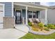 Charming front porch with cozy seating area and vibrant flower beds, adding to the home's charm at 7730 Demeter Dr, Fairburn, GA 30213