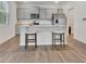 Contemporary kitchen with island seating, stainless steel appliances, and gray cabinetry at 7730 Demeter Dr, Fairburn, GA 30213