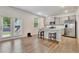 Modern kitchen with stainless steel appliances, granite countertops, and access to an outdoor patio at 7730 Demeter Dr, Fairburn, GA 30213