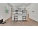 Bright kitchen with stainless steel appliances, granite countertops, and a view to an adjacent room at 7730 Demeter Dr, Fairburn, GA 30213