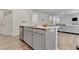 Kitchen island with granite countertops and stainless steel dishwasher in an open floor plan at 7730 Demeter Dr, Fairburn, GA 30213