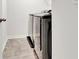 Laundry room shows large stainless steel front-loading washer and dryer against light gray stone-look flooring at 7730 Demeter Dr, Fairburn, GA 30213