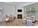 Comfortable living area featuring a fireplace, wood floors, and neutral decor at 7730 Demeter Dr, Fairburn, GA 30213