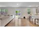 Open concept living space that connects the kitchen, dining, and living areas with natural lighting at 7730 Demeter Dr, Fairburn, GA 30213