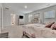 Carpeted primary bedroom shows comfortable space, dresser, and TV at 7730 Demeter Dr, Fairburn, GA 30213