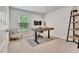 Home office featuring a sit-stand desk and natural light at 7730 Demeter Dr, Fairburn, GA 30213