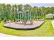 View of community playground with green slide, swings and benches at 7730 Demeter Dr, Fairburn, GA 30213